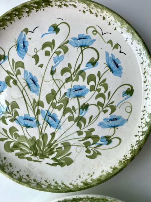 Pretty turquoise blue flowers and green leaves on a vintage, hand-painted wall-plate.