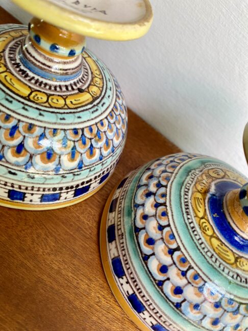 The pretty, hand-painted underside of a pair of Italian pottery vessels.