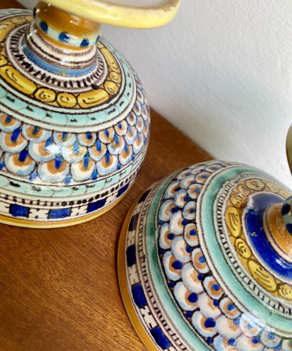The pretty, hand-painted underside of a pair of Italian pottery vessels.