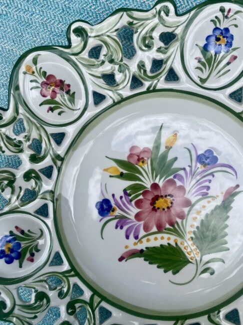 Hand-painted flowers on a vintage Portuguese wall plate.