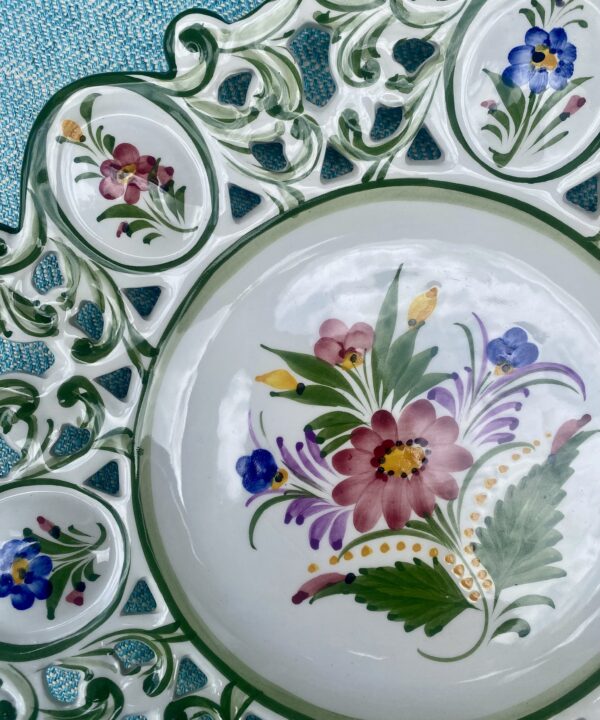 Hand-painted flowers on a vintage Portuguese wall plate.