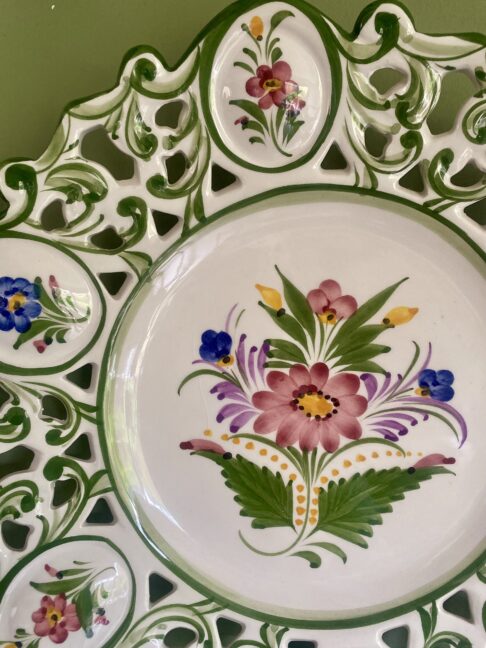 Pretty flowers hand-painted on a decorative Portugese wall plate.