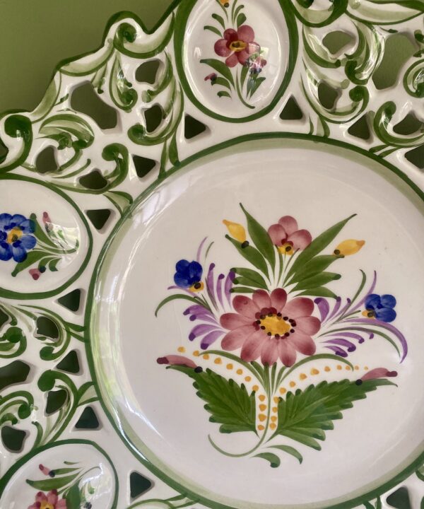 Pretty flowers hand-painted on a decorative Portugese wall plate.
