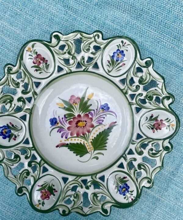 A large, sectional, decorative wall plate adorned with flowers. Handmade in Portugal.