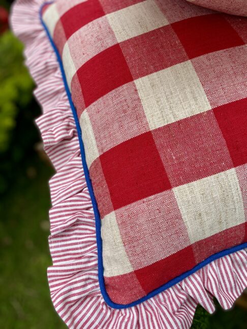 Red, white and blue cushions with a frill and contrast piping.