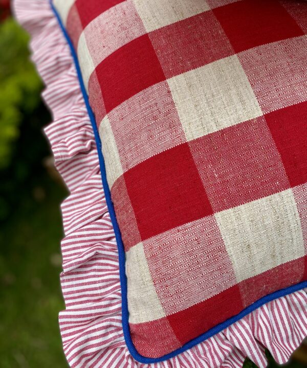 Red, white and blue cushions with a frill and contrast piping.