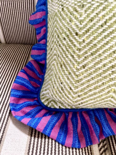Pretty frilled cushions in linen and tweed.