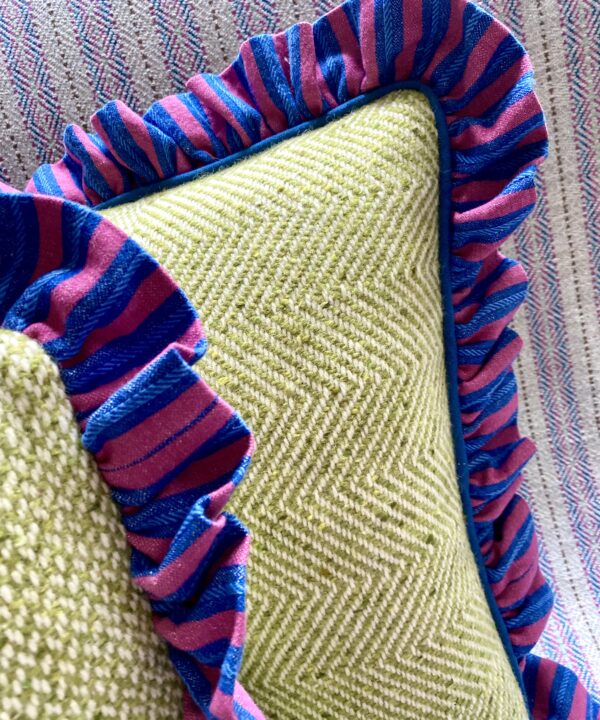 Frilly cushions with pink and blue striped linen trim and Donegal tweed cover.