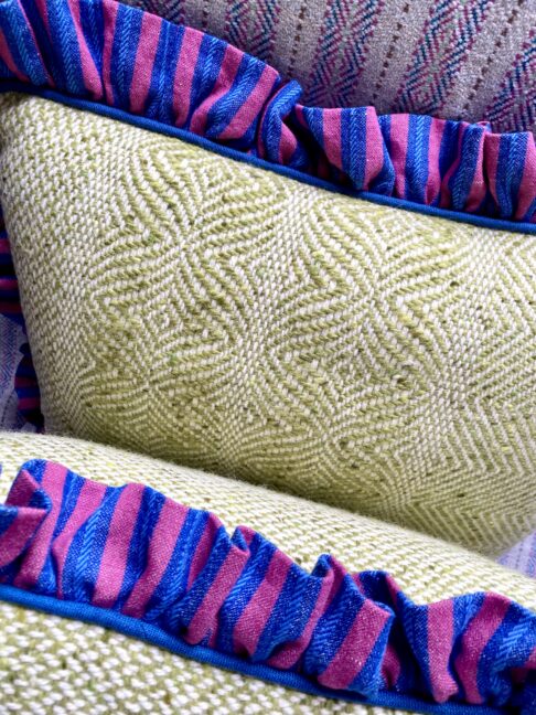 Handmade tweed cushions with linen frilled trim.