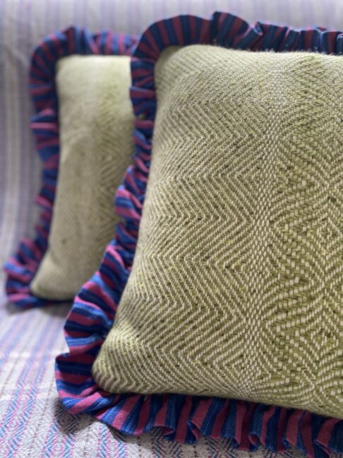 Luxury handmade Donegal tweed cushion covers with contrast frilled borders.