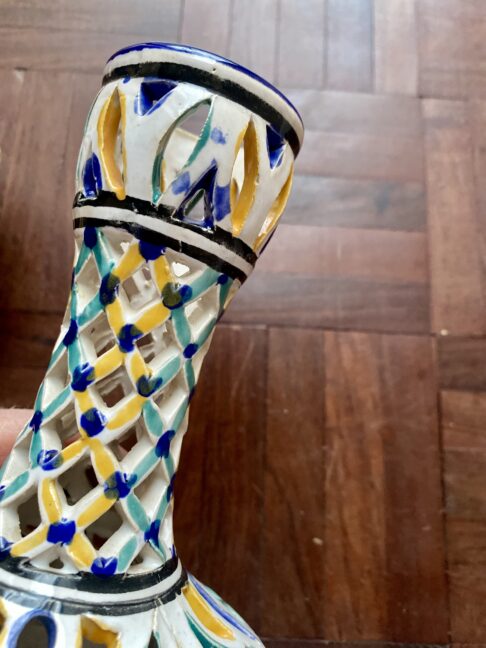 Hand-painted detail on a lattice pattern vase neck.