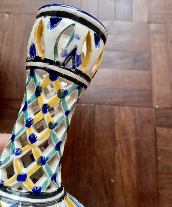 Hand-painted detail on a lattice pattern vase neck.