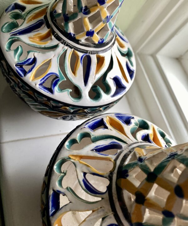 Handmade pots with pierced detailing.