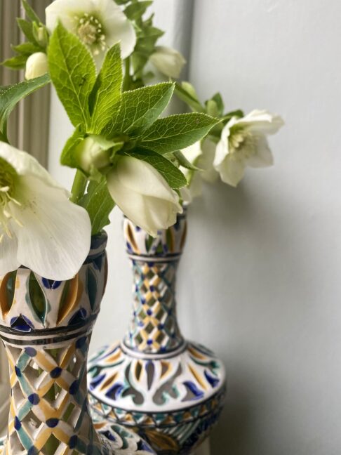 Seasonal blooms in pretty pierced decorative vases.