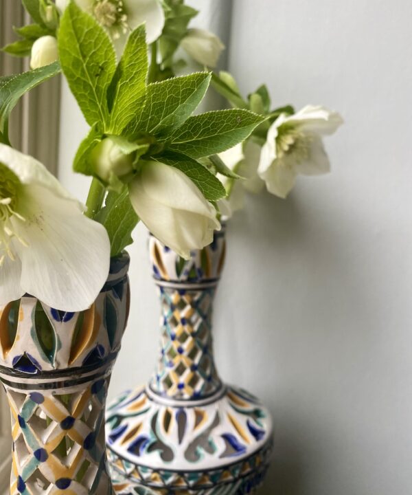 Seasonal blooms in pretty pierced decorative vases.