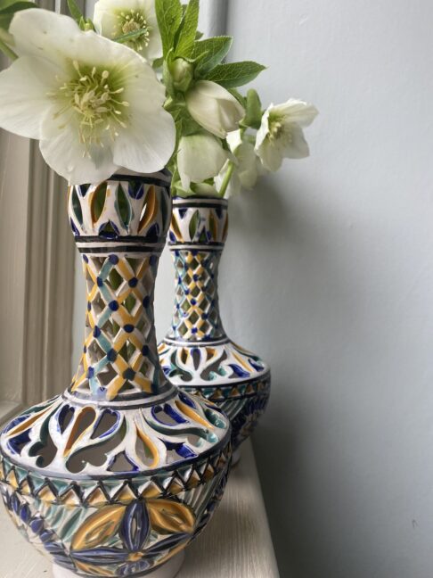 A pair of pierced, decorated pots.