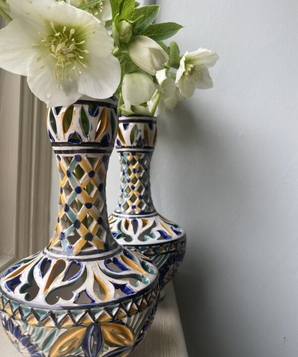 A pair of pierced, decorated pots.