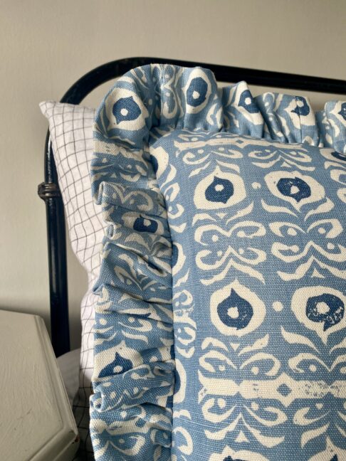 Pale blue frilly cushions in a hand-printed linen.