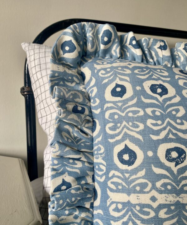 Pale blue frilly cushions in a hand-printed linen.