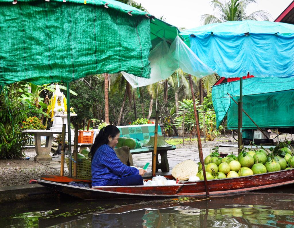 Floating markets in Thailand. This lady is selling pomelos.