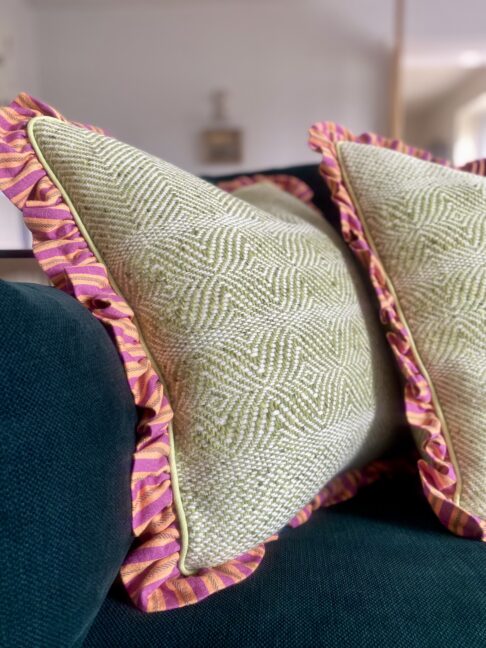 Colourful tweed and linen cushions in lime green, orange and pink.