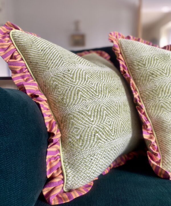 Colourful tweed and linen cushions in lime green, orange and pink.