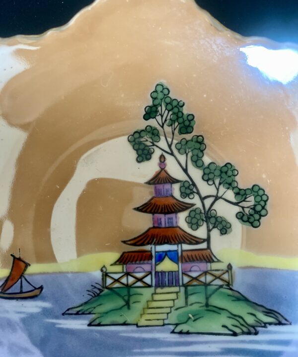 Hand-painted pagoda in rainbow colours on a vintage Japanese dish.