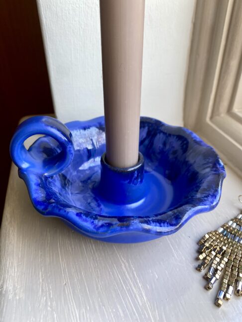 A vibrant blue candlestick handmade in Greece.