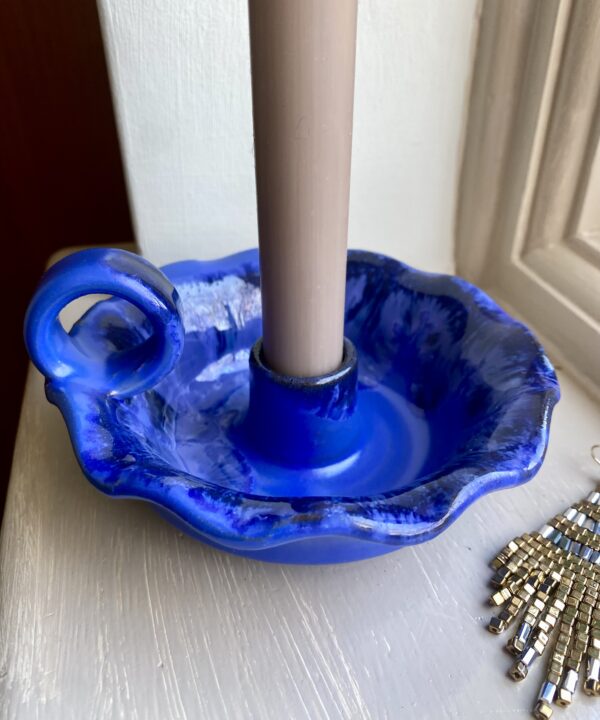 A vibrant blue candlestick handmade in Greece.