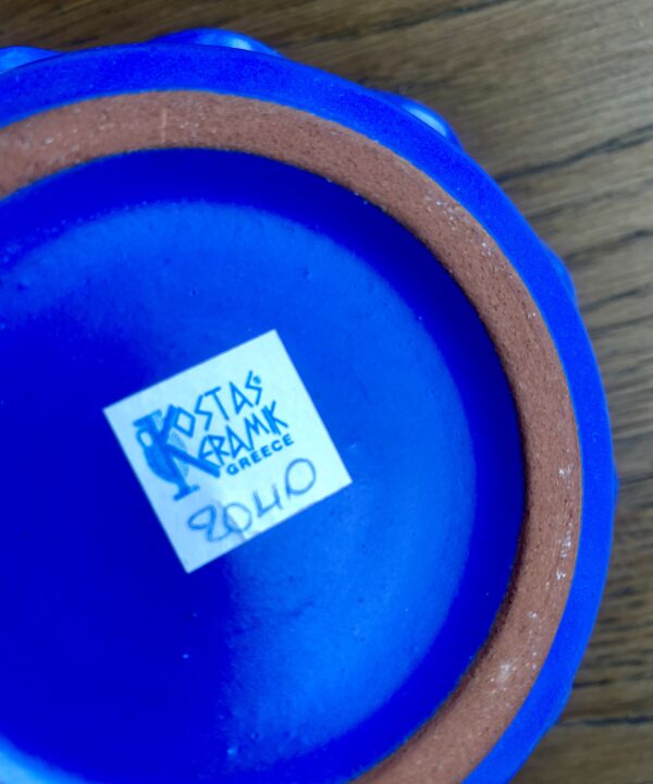 Back stamp on a handmade Greek candle holder in cobalt blue.