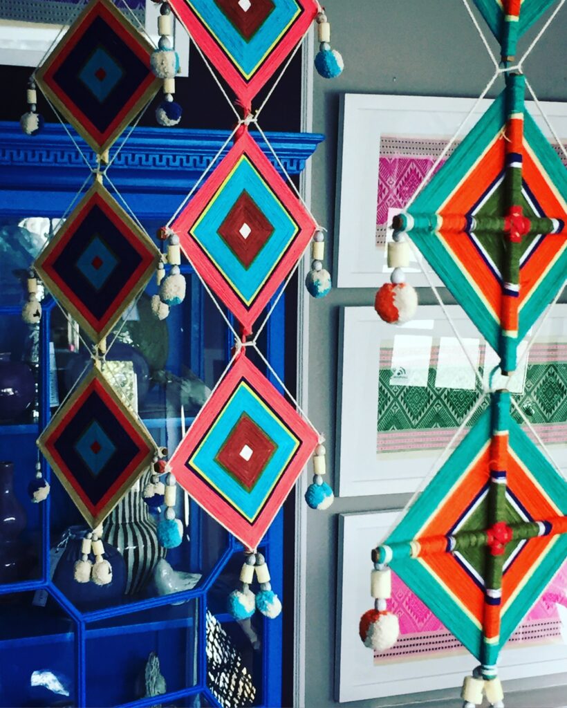 Colourful hanging Thai garlands handmade from cotton, bamboo and beaded pom poms.