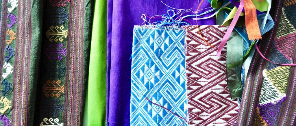Colourful Thai textiles including hand-woven silks in traditional patterns.