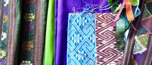 Colourful Thai textiles including hand-woven silks in traditional patterns.
