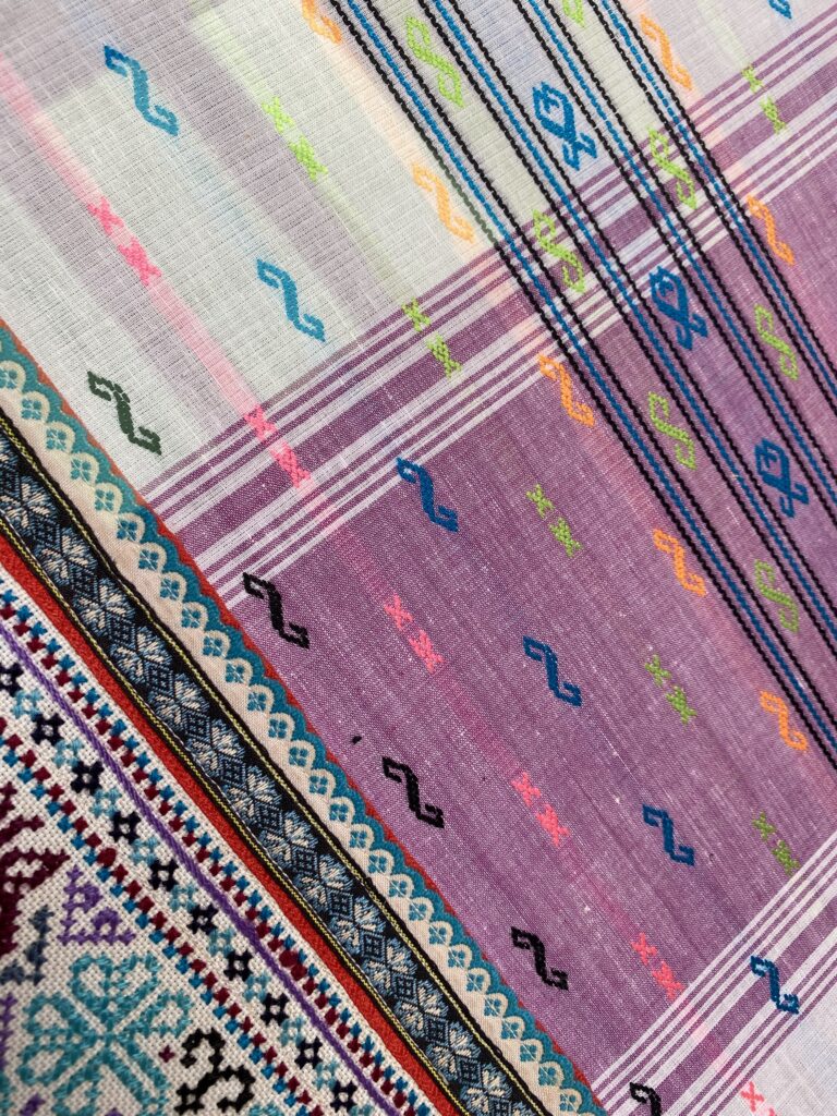 Rainbow-coloured traditional Southeast Asian textiles.