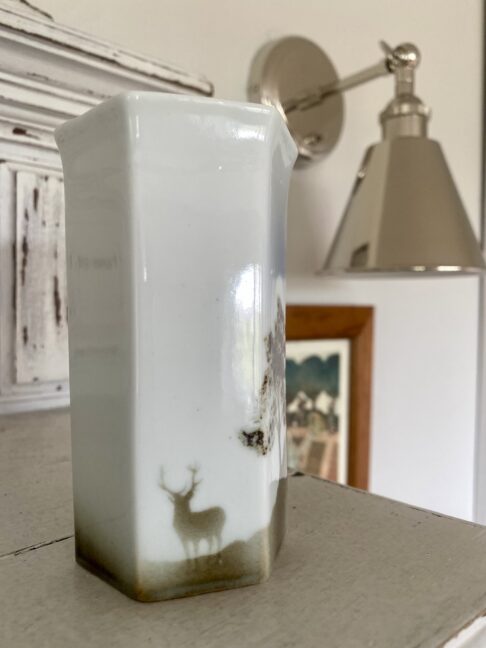 Small, hexagonal pottery bud vase with a stag in a Scottish landscape design.