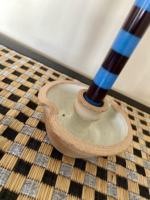 Handmade pottery candlesticks in a rustic style with an ivory interior glaze.