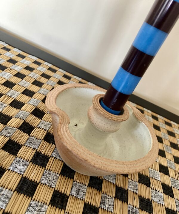 Handmade pottery candlesticks in a rustic style with an ivory interior glaze.