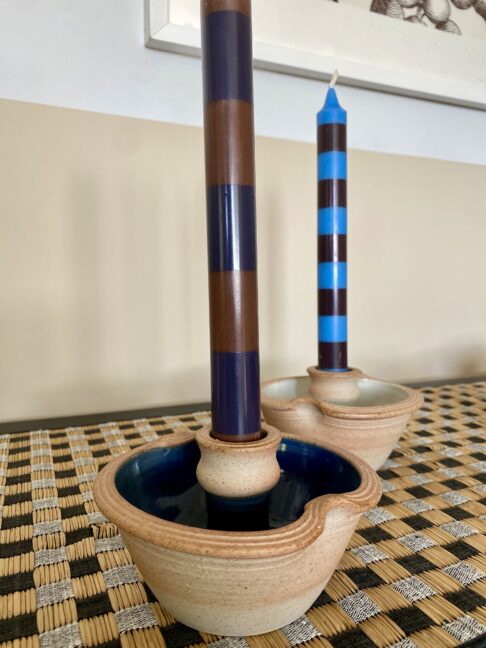 Rustic ceramic candleholders with a blue glaze.