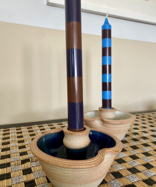 Rustic ceramic candleholders with a blue glaze.