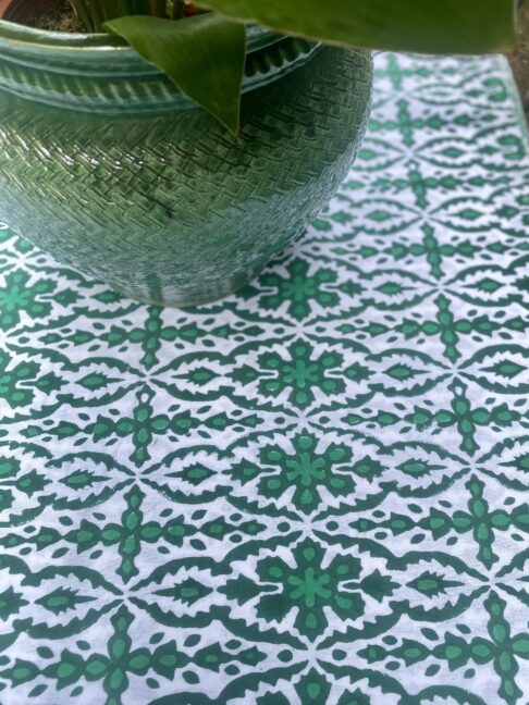 Green block print tablecloth, perfect for summer dining - or indeed the Christmas table! Shown here with a glazed green indoor planter.