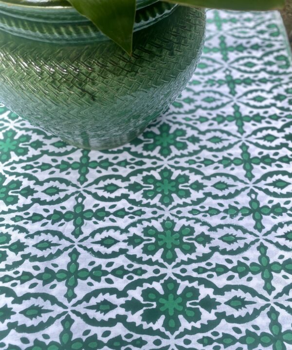 Green block print tablecloth, perfect for summer dining - or indeed the Christmas table! Shown here with a glazed green indoor planter.