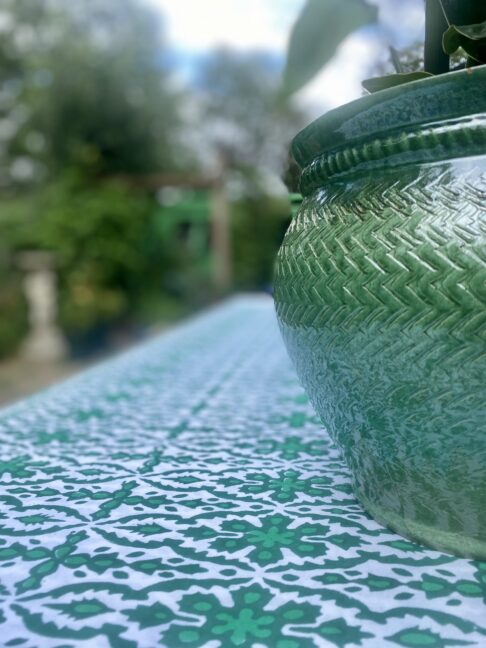 A bold, green outdoor tablecloth. Indian block print all-over design in vibrant pea green.